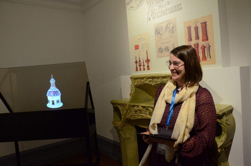 A person presenting the villa next to the display